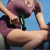 Person using a massage roller on their leg against a clear blue sky.